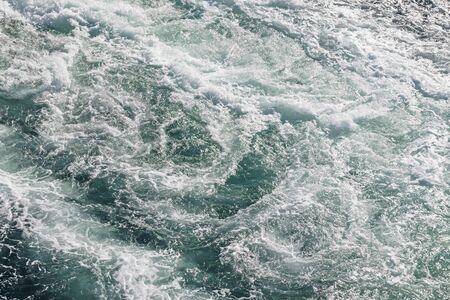 turquoise color sea and ship wave in the seaの写真素材