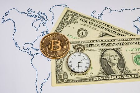 Bitcoin is an innovative payment network and a new type of currency. close up bitcoin coin on background with US dollars and clock.の写真素材