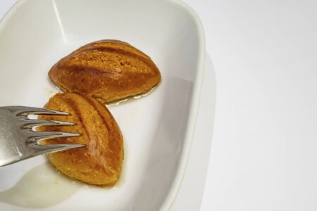 ready to eat traditional turkish dessert sekerpare in white plate on backgroundの写真素材