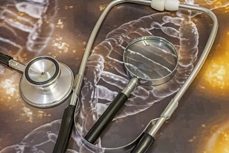 stethoscope, magnifying glass and genetic diseases researchの写真素材