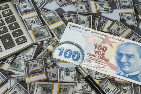 close up turkish lira banknotes with calculator and magnifier on background
