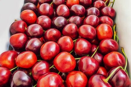 close up red cherries in a boxの写真素材