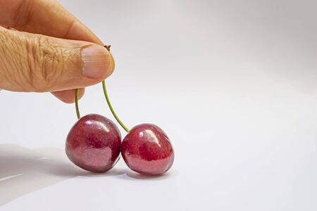 red cherries on a white background
