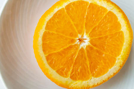 slices of orange on white plate backgroundの写真素材