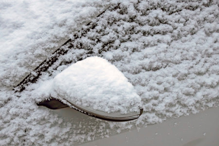 snow covered car and rearview mirrorの写真素材