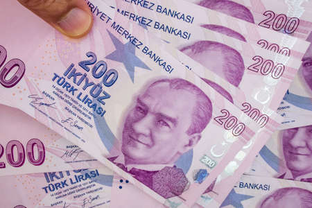 istanbul, turkey-april 29,2021.200 turkish lira banknotes on hand for finance and economy.のeditorial素材