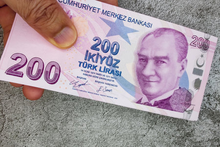 istanbul, turkey-april 29,2021.200 turkish lira banknotes on hand for finance and economy.のeditorial素材