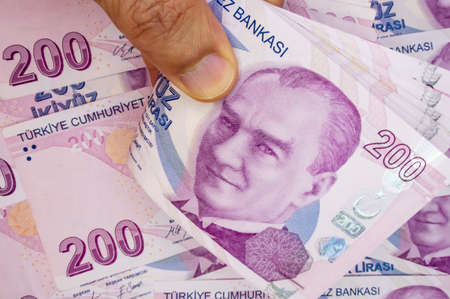 istanbul, turkey-april 29,2021.200 turkish lira banknotes on hand for finance and economy.のeditorial素材