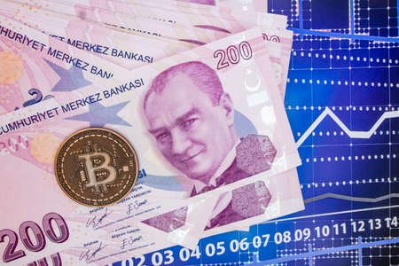 istanbul, turkey-april 29,2021.Turkish lira banknotes and bitcoin coin on background.のeditorial素材
