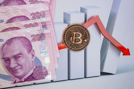 istanbul, turkey-april 29,2021.Turkish lira banknotes and bitcoin coin on background.のeditorial素材