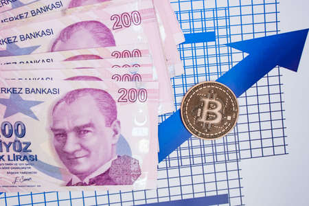 istanbul, turkey-april 29,2021.Turkish lira banknotes and bitcoin coin on background.のeditorial素材
