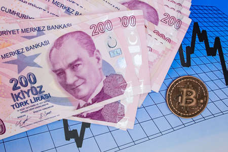 istanbul, turkey-april 29,2021.Turkish lira banknotes and bitcoin coin on background.のeditorial素材