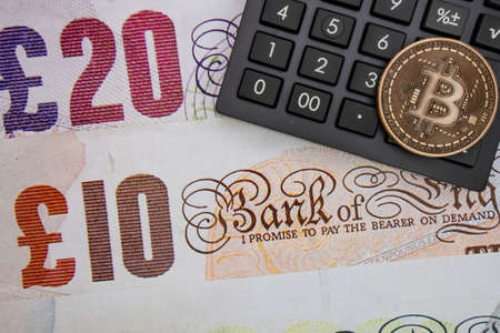 istanbul, turkey-may 21,2021.cryptocurrency mining and bitcoin coin for finance and economy with calculator.のeditorial素材