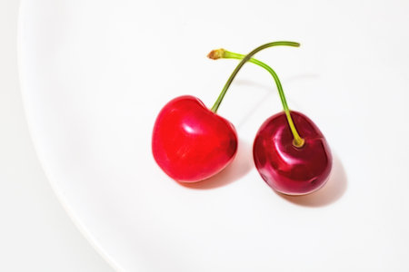 close up red cherries on white plateのイラスト素材