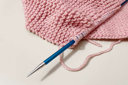 close up knitting wool and knitting on background
