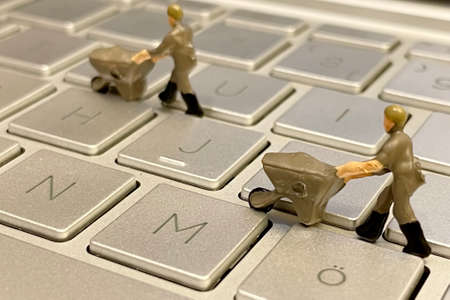 IT and computer world and miniature working people.の写真素材