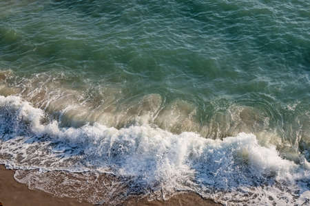 clear sea and waves on the shore in summer