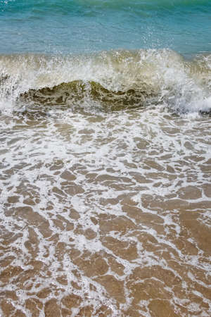 clear sea and waves on the shore in summerの写真素材