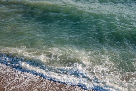 clear sea and waves on the shore in summer