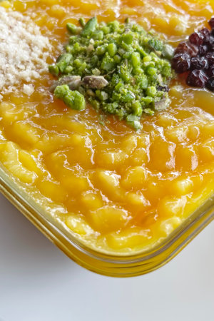 Traditional Turkish dessert zerde with grated peanuts, coconut and raisins.