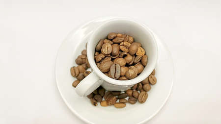 white coffee cup and roasted coffee beans