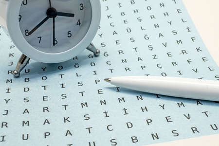 Crossword ,Puzzle and pencil for leisure and entertainment with clockの写真素材