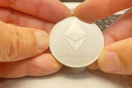 Cryptocurrency mining. Close-up physical cryptocurrency in hands