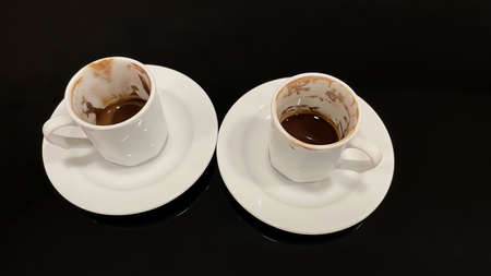 coffee cups on glossy and black background