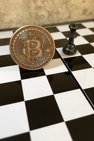 istanbul,Turkey.June 22,2022.cryptocurrency mining. Close-up bitcoin coin and chess gameのeditorial素材