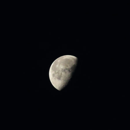 Half moon in the night sky. Close-up of a half moon.の写真素材