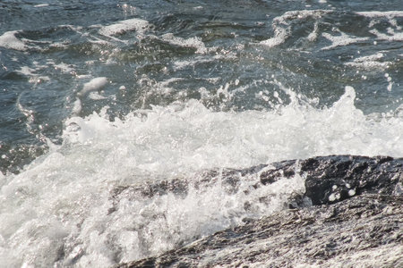 On a colorful autumn day enlivened by the breeze of the light wind, the sun is shining in the sky and the wavy surface of the sea offers a fascinating view. Wavy Seascape .の写真素材