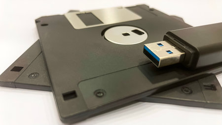 The Evolution of Data Storage. The striking visual comparison between an old black floppy disk and...