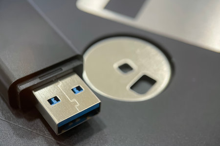 The Evolution of Data Storage. The striking visual comparison between an old black floppy disk and...