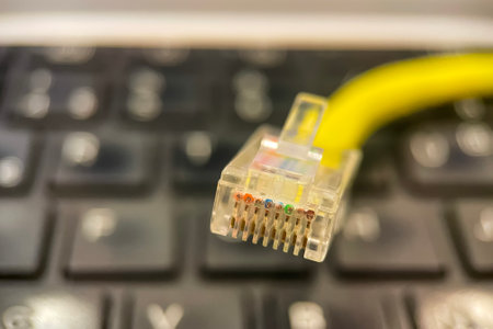 yellow network cable on the keyboard of a laptop. close-up.Ethernet Cable Close-up.