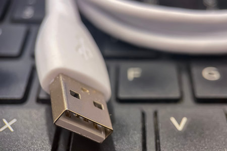 USB cable on the keyboard of a laptop close-up macro photography