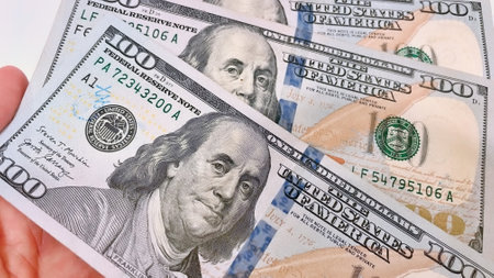A Fan of $100 Bills.A close-up photo of a fan of $100 US dollar bills. The bills are arranged...