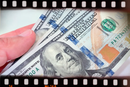 A Fan of $100 Bills.A close-up photo of a fan of $100 US dollar bills. The bills are arranged neatly, with the portrait of Benjamin Franklin visible on each bill.の写真素材