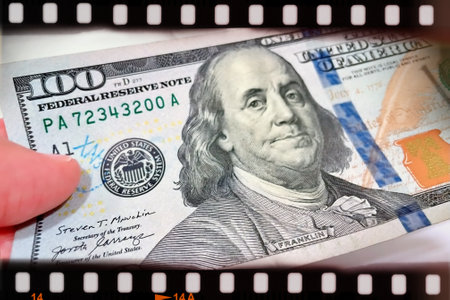 A Fan of $100 Bills.A close-up photo of a fan of $100 US dollar bills. The bills are arranged...