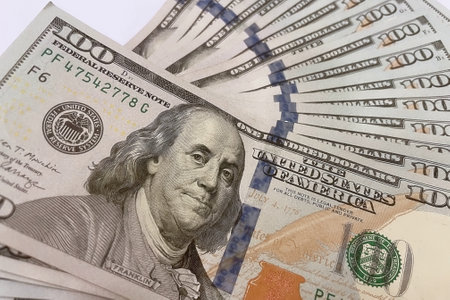 Close up view of one hundred dollar banknotes on white background.