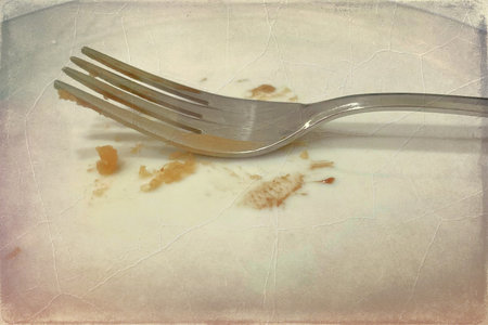Dirty fork on old paper background with space for text or imageの写真素材