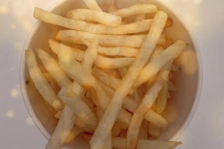 Golden French fries with crisp texture, warm lighting, macro view