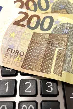 Calculator and Euro Bills.A professional stock photo of 200 euro banknotes on a calculator, ideal for financial and business concepts.の写真素材