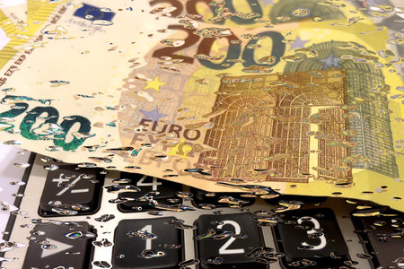 Calculator and Euro Bills.A professional stock photo of 200 euro banknotes on a calculator, ideal for financial and business concepts.の写真素材