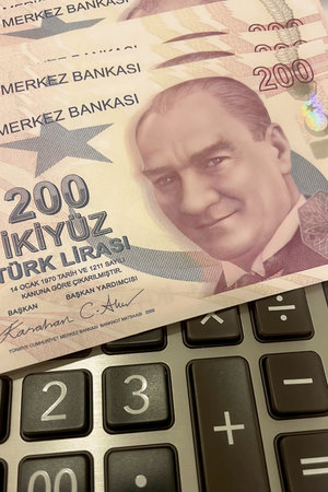 Turkish Lira and Calculator Finance Concept.200 TRY banknotes on calculator representing Turkish economy, budgeting, and financial planning.の写真素材