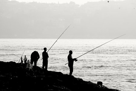 Fishermen on the coast of Istanbul in Turkey in black and whiteの写真素材