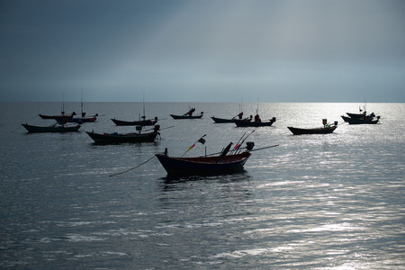 The Asian fisherman’s ship that sail out from coast to the sea for catching fishes back.