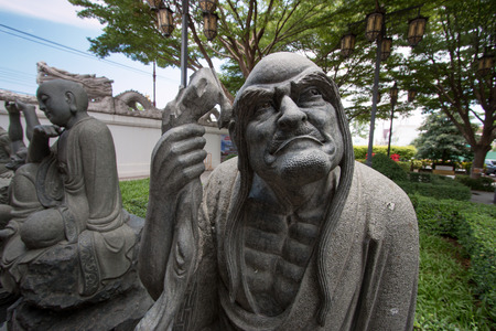 Detail of A Chinese Statue in the Buddhist temple in Thailand.の写真素材