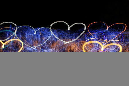 heart shaped light trails on a black background