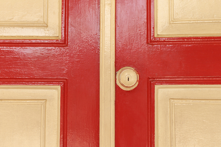 rusted door knob on red wooden doorの写真素材