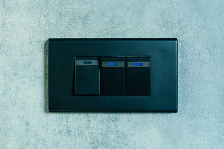 Light switch on concrete texture wall background